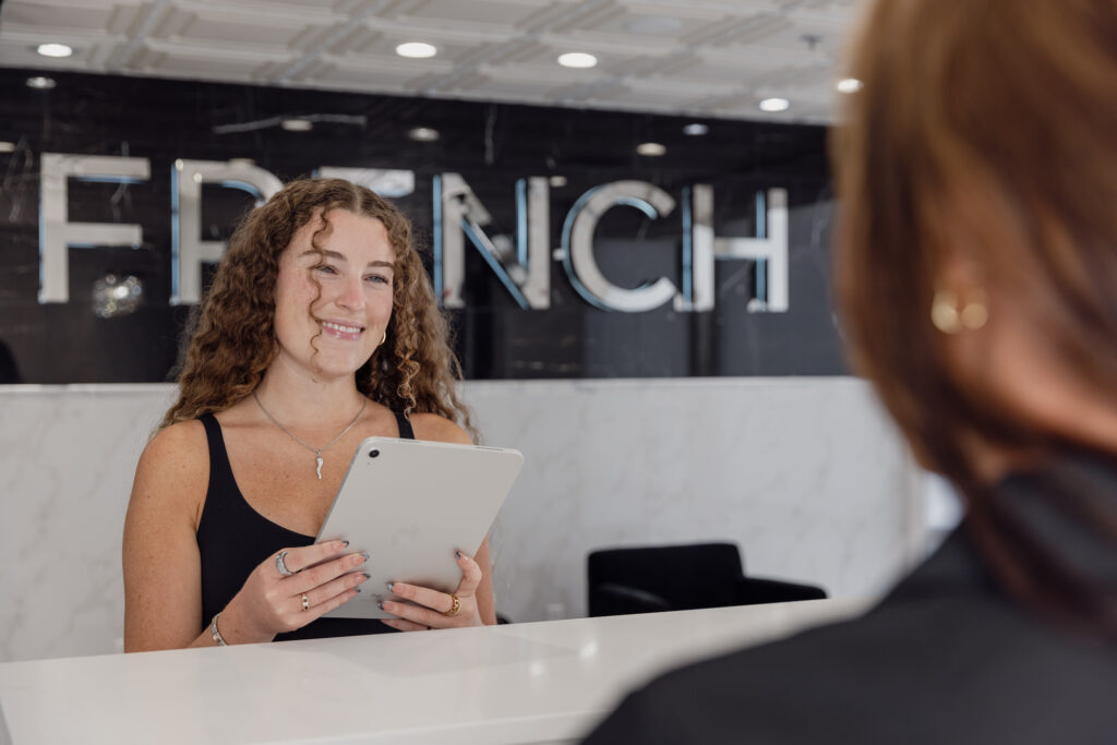One of our desk assistants checks in a patient with an iPad for a nonsurgical facelift in St. Charles, IL.